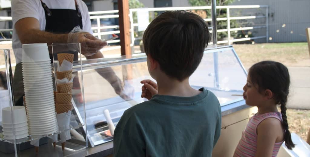 Two eager kids eager to taste Carretto gelato at Arundel family day in Keilor